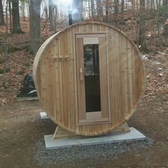 Knotty Barrel sauna in the country with wood stove