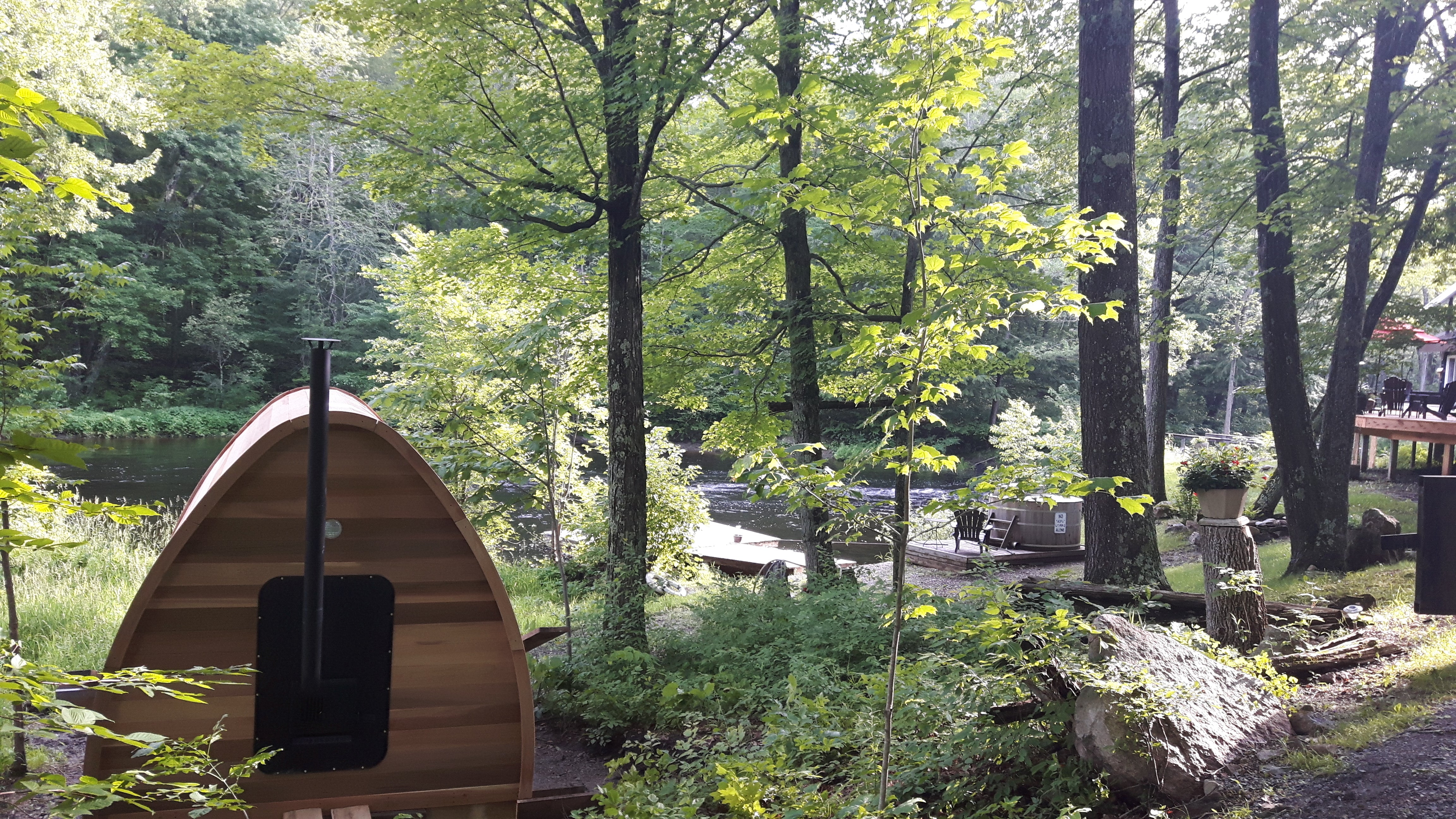Back of Red Cedar Pod sauna with traditional heater